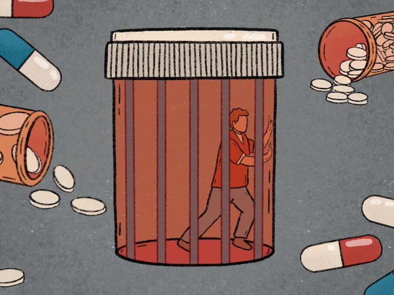 Conceptual illustration of an inmate trapped in a pill bottle with spilled pill bottles circling the giant pill bottle.