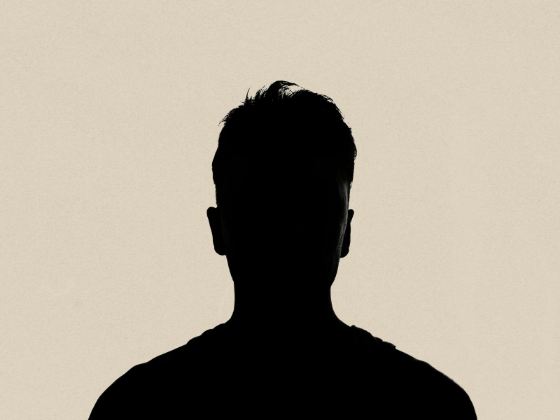 Plain white background with an black outline of a person from shoulder-up.